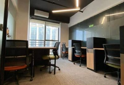 Private office suite with multiple workstations and grey carpeting.