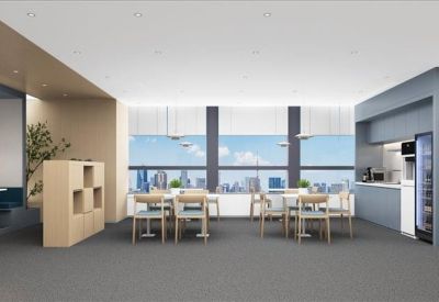 Light-filled breakout area with dining tables and a city view through large windows.
