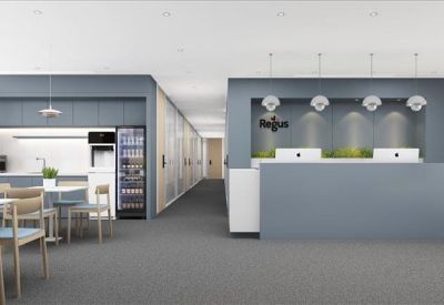 Modern reception lobby with a large blue front desk and warm lighting.