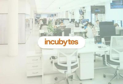 Open-plan workspace with multiple desks and seating.