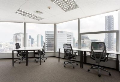 Empire Tower office space with desks facing large windows overlooking the city skyline.