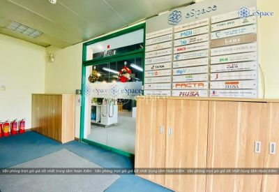 Reception area with a directory sign and wooden cabinets.