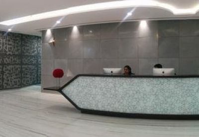 Lobby area with a modern reception desk and decorative wall pattern.
