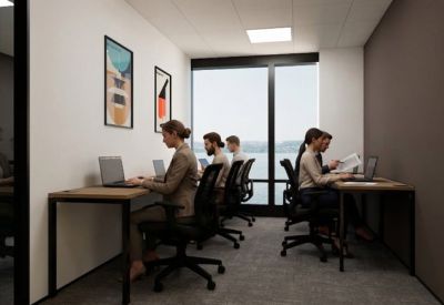 Private office space with four people working at desks near a window.