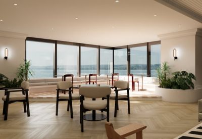 Bright breakout area with cafe-style seating and panoramic water views.