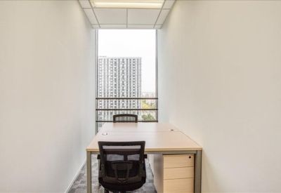 Narrow two-person office with a large window overlooking the city skyline.