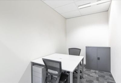 Small private office with a white desk and grey storage cabinet.