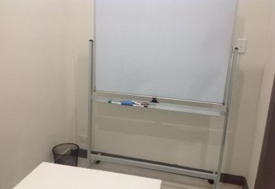 Private office space at 1023 Botany Road featuring a mobile whiteboard and waste bin.