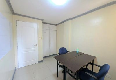 Compact office room with two chairs and a table.