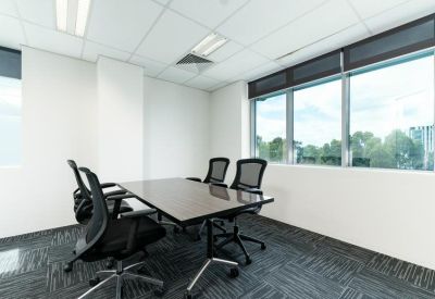 Private meeting room with a sleek table and four black mesh chairs.