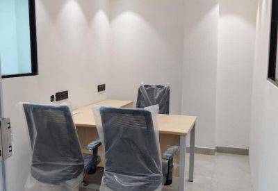 Reception area with decorative flooring and brick accent wall.