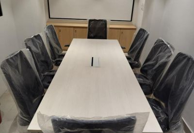 Small meeting room with three chairs and a table.