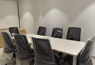 Conference room with long table and eight chairs.
