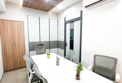 Clean, white meeting room featuring ergonomic chairs and a minimalist conference table.