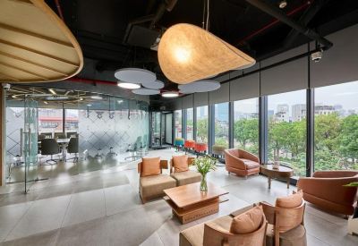 Lounge area with leather armchairs and a decorative curved glass partition.