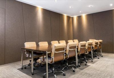 Modern conference table with a black screen and frosted glass partition.