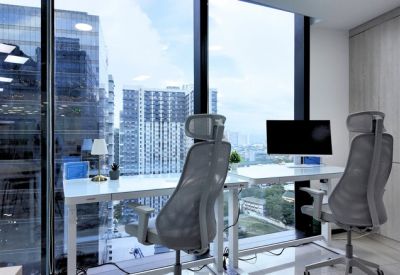 Pair of modern white desks positioned by floor-to-ceiling windows.