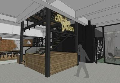 Industrial style reception area featuring a wood-paneled counter and bold black staircase.
