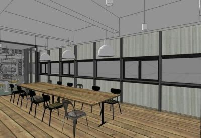 Long wooden meeting table in a minimalist room with industrial window frames.