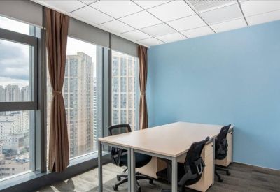 Bright corner office with blue feature wall and city views.