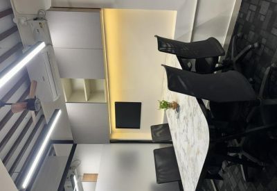 Contemporary meeting room with a marble-patterned table and black mesh chairs.