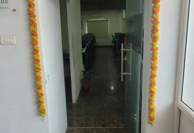 Entrance to the 141, LMS Street office decorated with traditional orange floral garlands and a festive banner.