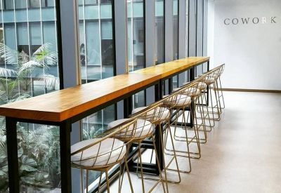 Window-side breakfast bar with wooden countertop and modern bar stools.