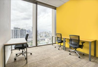Private office space with a yellow feature wall and two desks facing large windows.
