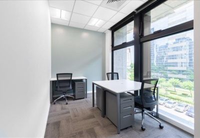 Private window office suite with two white desks and views of the city.