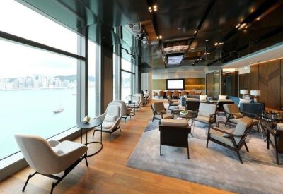 Spacious lounge area with floor-to-ceiling windows overlooking the harbor.