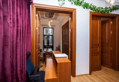 Reception entrance featuring wooden doorways and a decorative leaf garland.