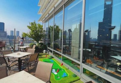 Building exterior view of 18F 826 Century Avenue showcasing the modern glass facade and rooftop terrace.