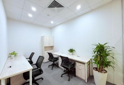 Private four-person office suite with white desks and black mesh chairs.