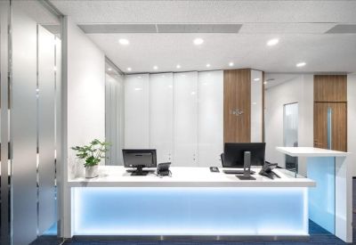 Professional reception desk with blue under-lighting and modern decor.