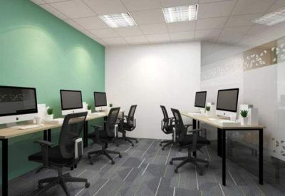 Coworking area with sleek desks, mesh chairs, and a decorative glass partition.