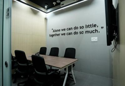 Private meeting room with black chairs and inspirational quote on the wall.