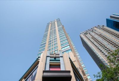 Exterior view of the SJ Infinite I Business Complex showing the modern high-rise architecture against a clear blue sky.