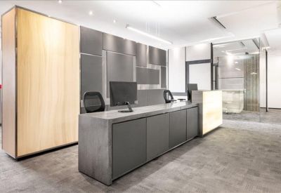 Professional reception area with a long grey front desk and wooden feature wall.