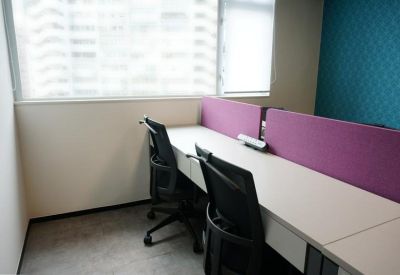 Private office suite with a white desk and purple privacy screens.