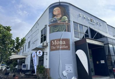 Exterior facade of the Mona The Hustler building at 22-1, Jalan Radin Bagus 3 with mural art.