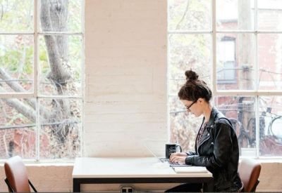 Sunny window-side workstation with a white desk and natural light.