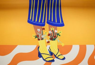 Close-up of a colorful mural depicting legs in yellow socks with flowers growing out of them.