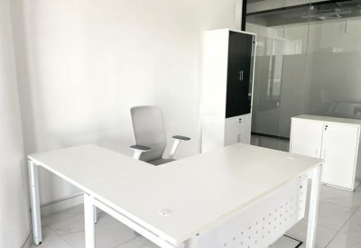 Private office with a single white desk and chair.