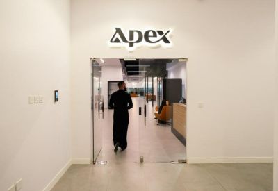 Modern glass entrance with Apex company logo above the door.