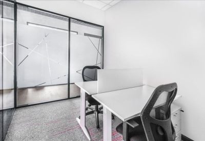 Private two-person office suite with white desks and mesh chairs.