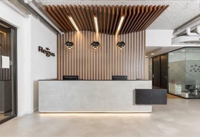 Professional reception desk with a vertical wood-slat feature wall and branded logo.
