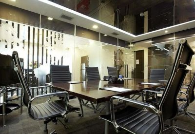 Modern conference room with a large dark wood table and ergonomic black chairs.