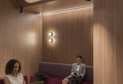 Quiet wooden booth with curved ceiling lights, perfect for focus work or private discussions.