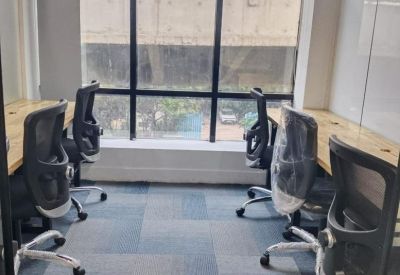 Internal four-person office suite with natural light from a large window.