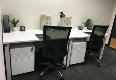 Double workstation setup with white desks and under-desk storage units.